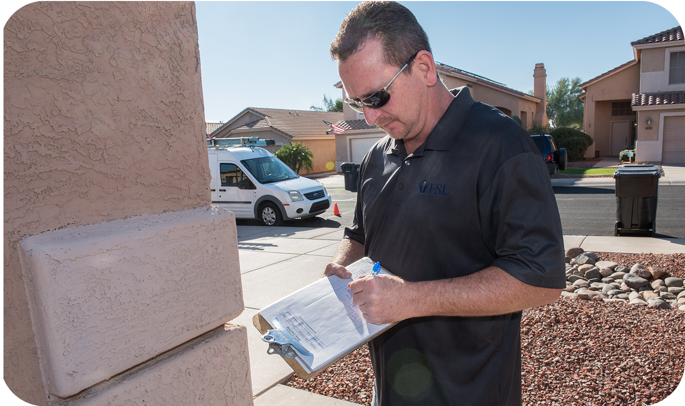 A repair man filling out a form