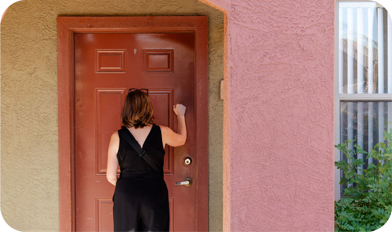A nurse knocking on a door to make a home visit