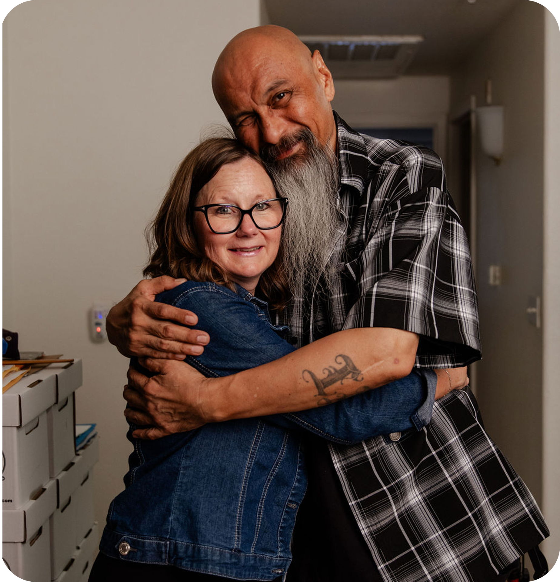 A man embracing a side hug from a woman