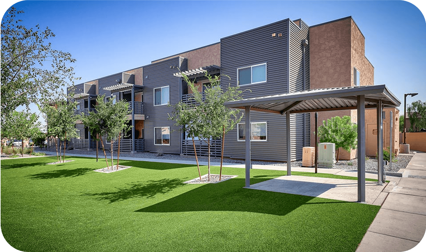 exterior of a building with a lush green lawn in front